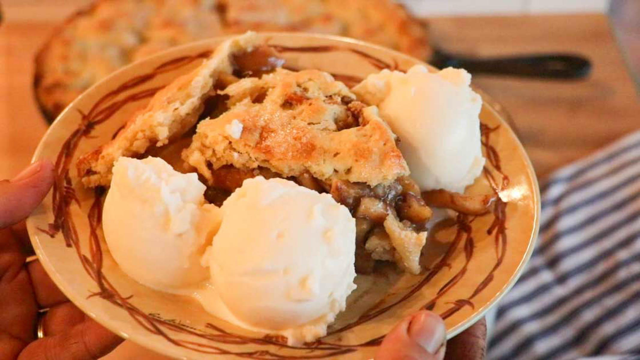 piece of sourdough apple pie on a plate with homemade vanilla ice cream