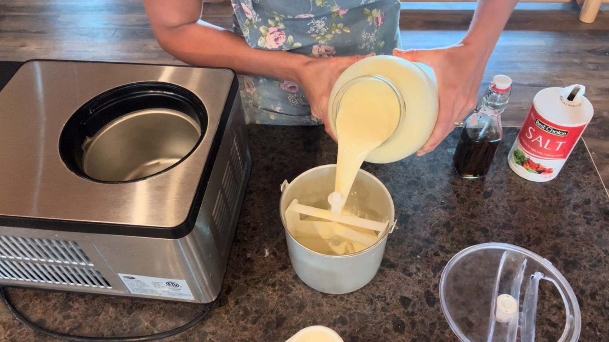 pouring cream into ice cream maker for vanilla ice cream