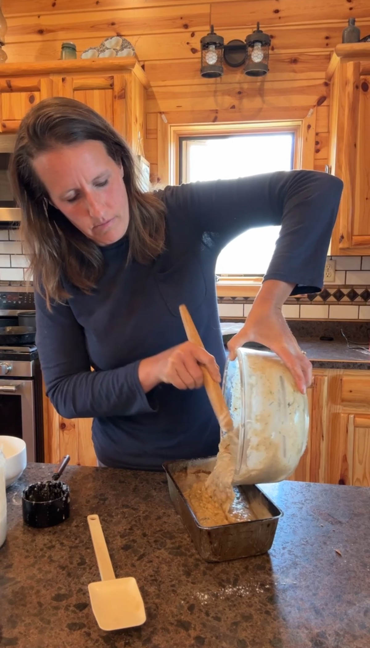 pouring zucchini bread into loaf pan