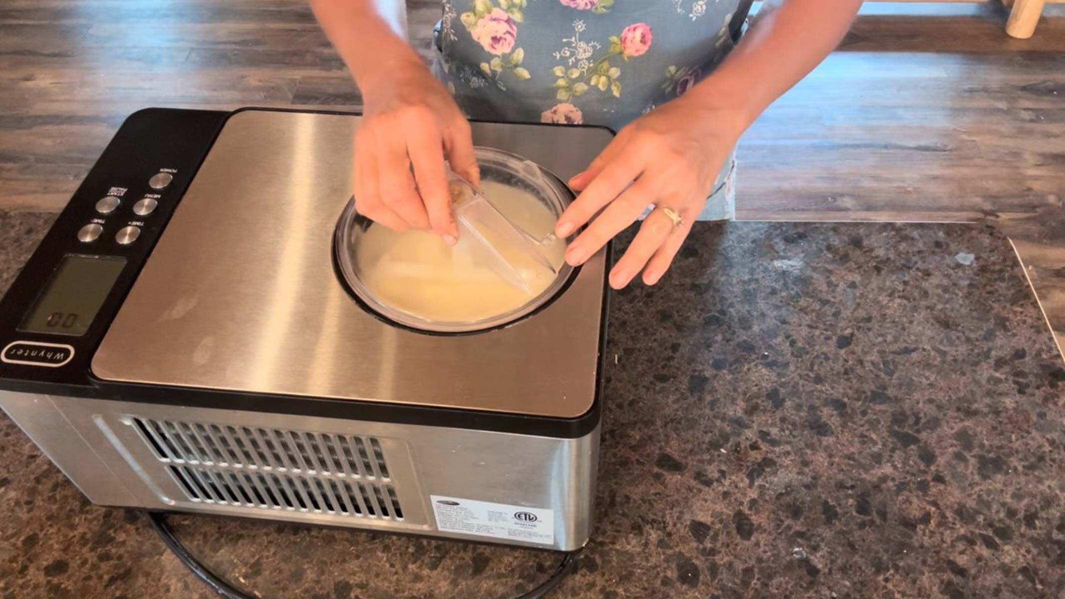 putting lid on ice cream maker for vanilla ice cream
