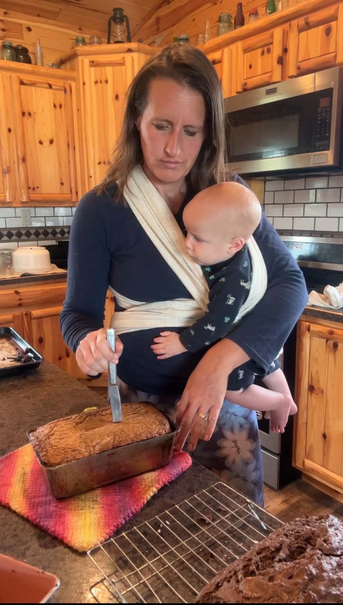 testing sourdough zucchini bread with a knife to see if it's done