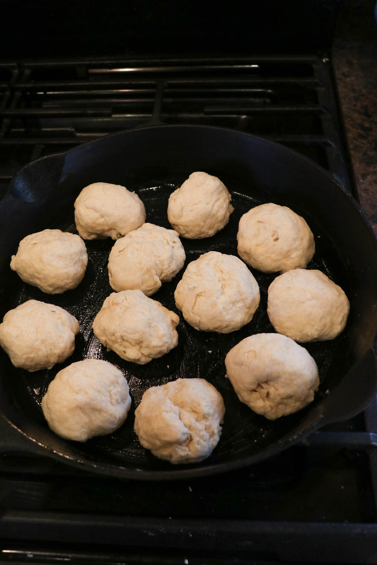 sourdough drop biscuits in cast iron skillet ready to bake