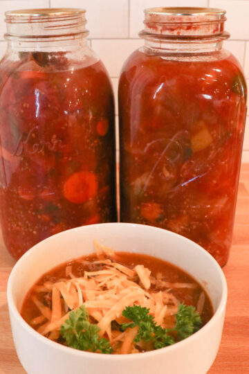 bowl of canned vegetable soup with jars square
