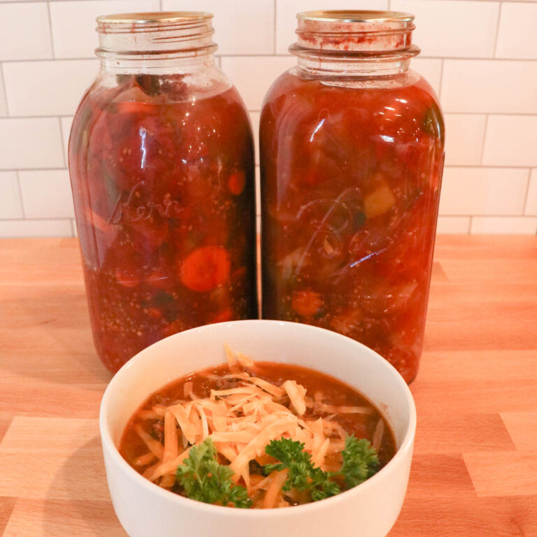 bowl of canned vegetable soup with jars square